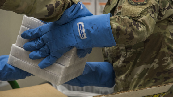 Soldiers handle case of Pfizer COVID-19 vaccine