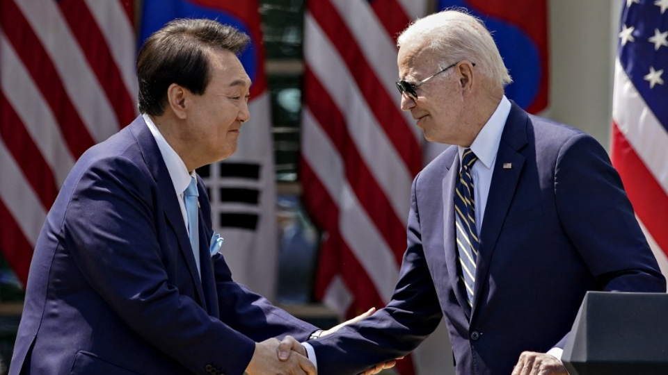 South Korean President Yoon Suk-yeol and U.S. President Joe Biden shake hands at summit.