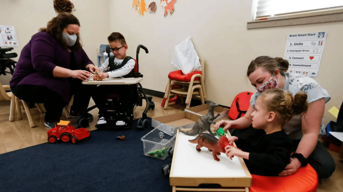 Special needs teachers work with students in classroom