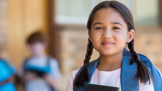 Student with backpack and notebook