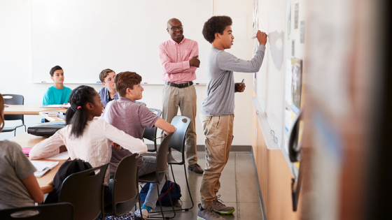 Student writes on whiteboard