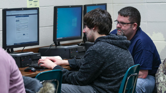 Students and families complete FAFSA forms online during an assistance event at Greenwood Community High School