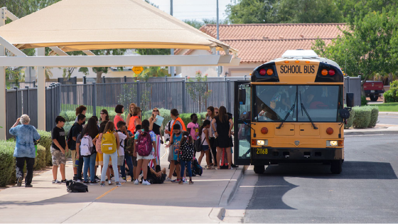 Students board a school bus after finishing their first day at Sanborn Elementary School