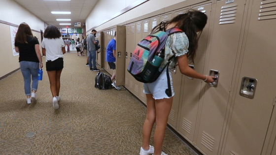 Students check their lockers as they arrive for the first day of the 2021-22 school year