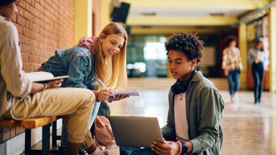 Students complete coursework in school hallway