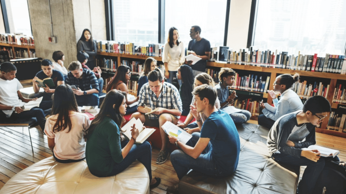 Students discuss and read in a library