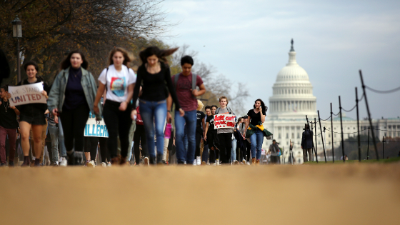 Students march along the National Mall during a protest