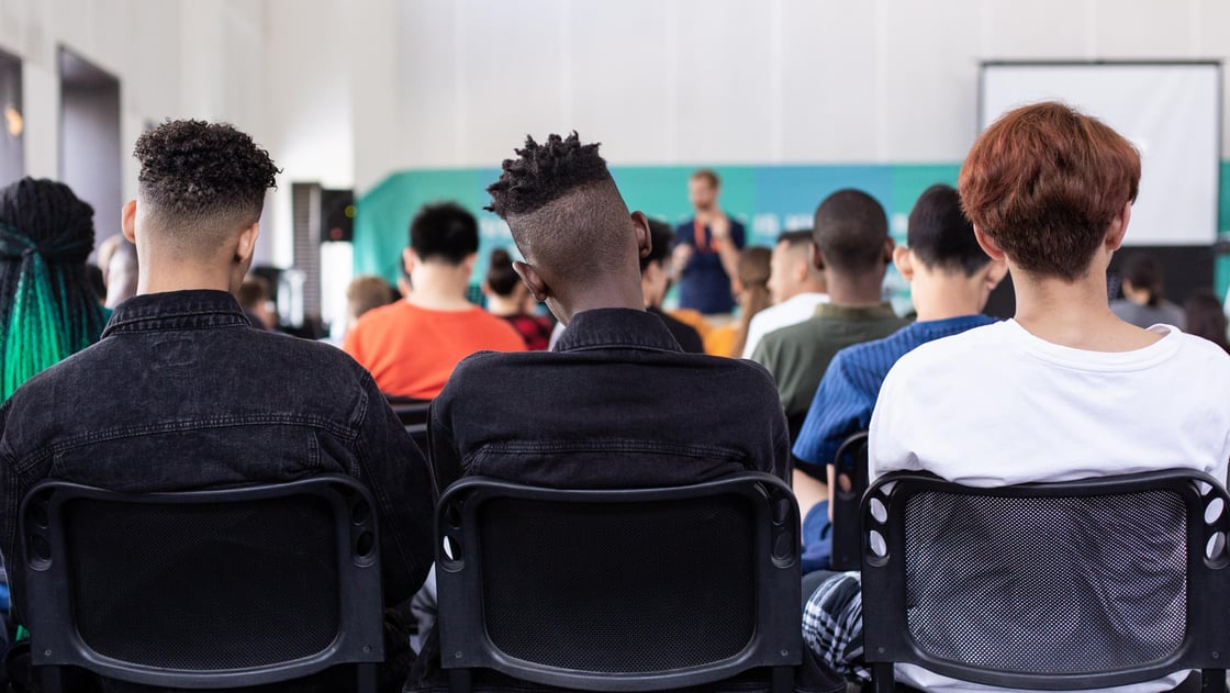 Students sitting at the back of a classroom