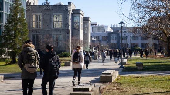 Students walking on a pathway on a college campus