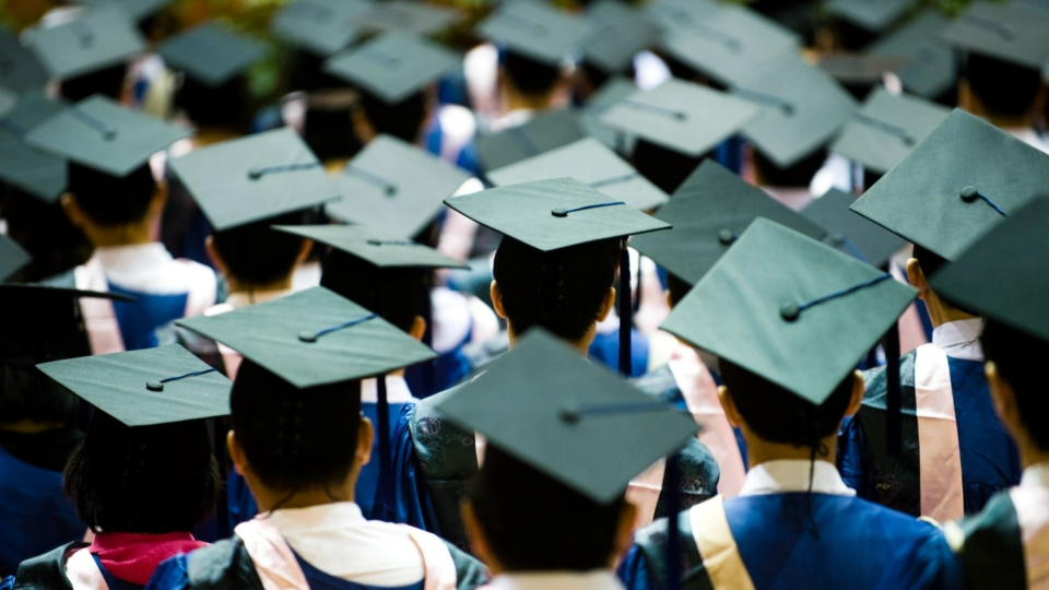 Students with graduation caps gather for ceremony