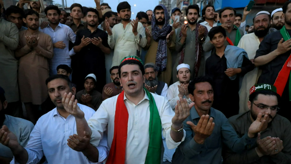 Supporters of Pakistan's former Prime Minister Imran Khan pray for Khan after the Supreme Court ruled that his arrest was illegal