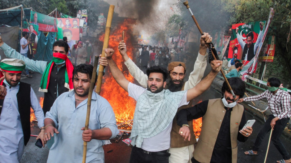 Supporters of former Pakistani Prime Minister Imran Khan block the road during protests