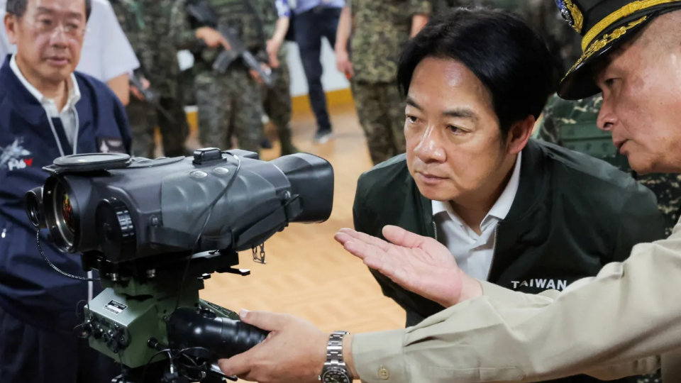 Taiwan President Lai Ching-te studies a Laser rangefinder during his visit to a military camp in Taoyuan, Taiwan