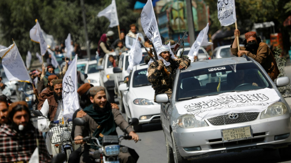 Taliban members drive in a convoy to celebrate the first anniversary of the withdrawal of U.S. troops from Afghanistan