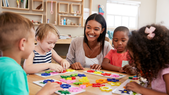 Teacher works with pre-school students