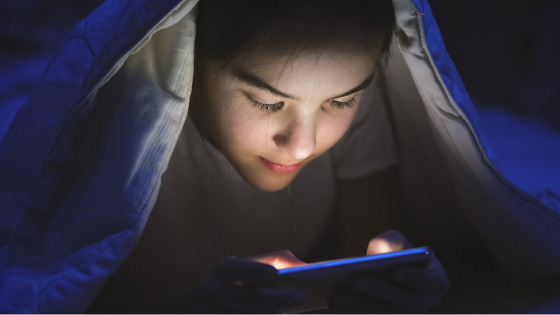 Teen uses smartphone at night