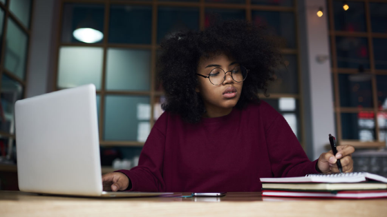 Teenager writing in notebook