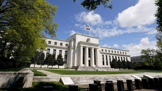 The Federal Reserve building is set against a blue sky in Washington