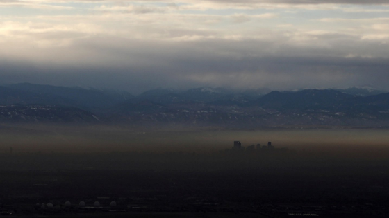 The Rocky Mountains are pictured as a layer of air pollution hangs over Denver