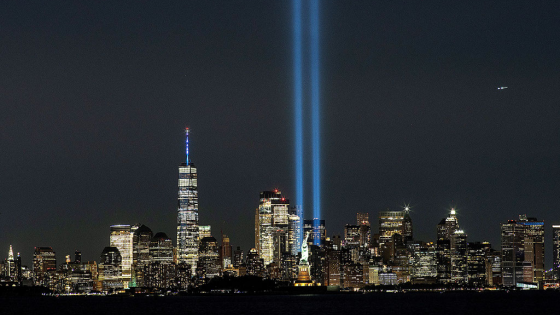 The Statue of Liberty and One World Trade Center are seen as the Tribute in Light shines in downtown Manhattan