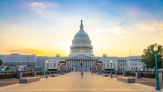 The U.S. Capitol building with the sun rising behind it