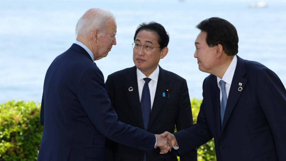 The U.S., Japanese, and South Korean heads of state greet each other