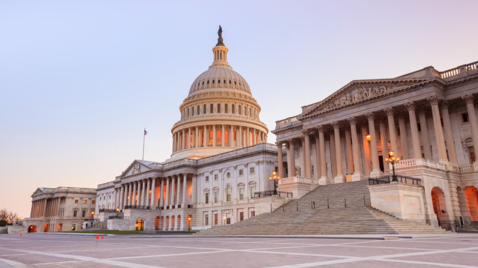 The United States Capitol building with the dome lit up in the evening