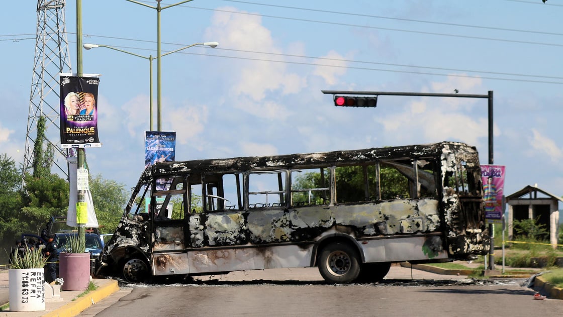 The burnt wreckage of a bus is seen a day after cartel gunmen clashed with federal forces