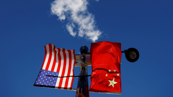 The flags of the United States and China fly from a lamppost in the Chinatown neighborhood of Boston