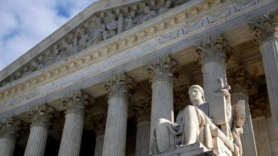 The portico of the US Supreme Court with the statute of the Guardian of Law in front