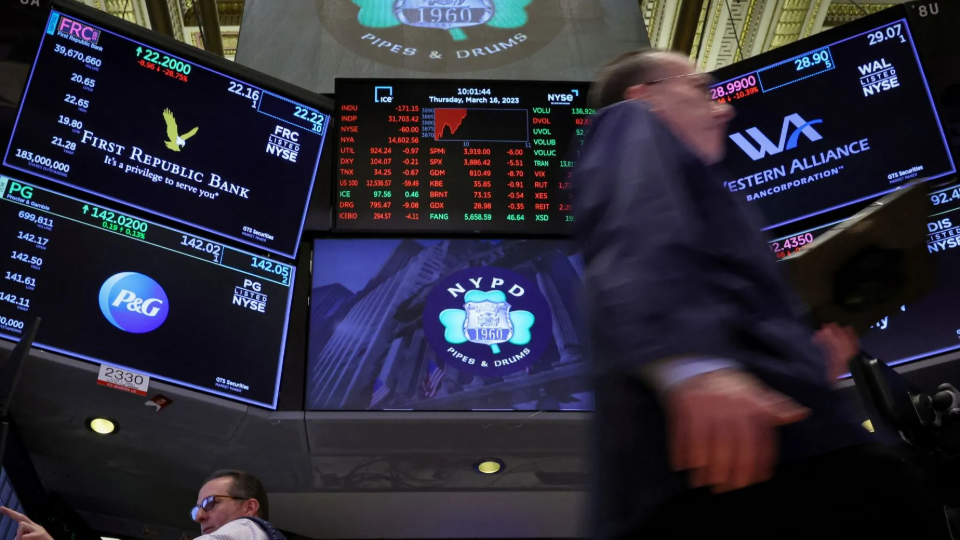 Traders work at the post where First Republic Bank stock is traded on the floor of the New York Stock Exchange