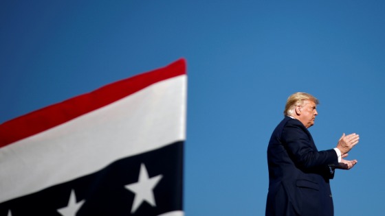 Trump claps during a campaign rally in Carson City