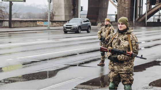 Two Ukrainian militiamen control a road