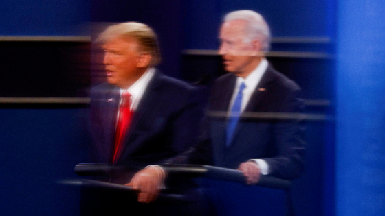 U.S. President Donald Trump and Democratic presidential nominee Joe Biden are reflected in plexiglass