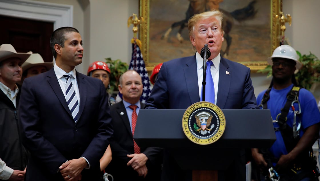 U.S. President Donald Trump speaks next to Federal Communications Commission (FCC) Commissioner Ajit Pai