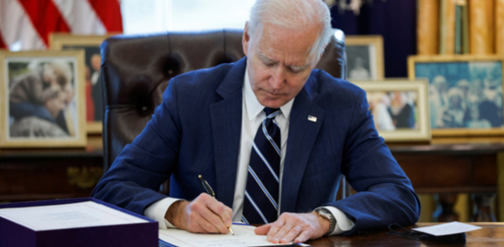 U.S. President Joe Biden signs the American Rescue Plan.