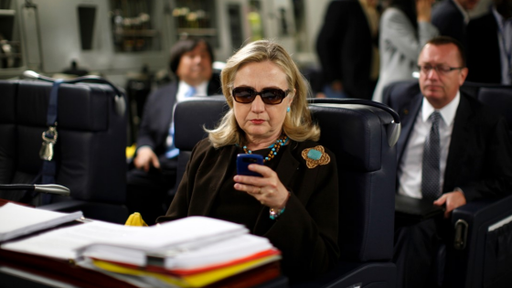 U.S. Secretary of State Hillary Clinton checks her PDA upon her departure in a military C-17 plane from Malta bound for Tripoli