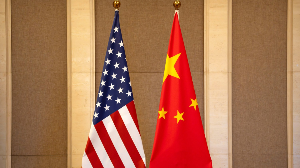 U.S. and China flags sit side-by-side.