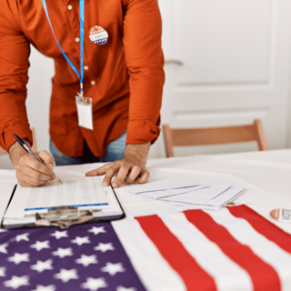 U.S. election poll worker fills out form on clipboard