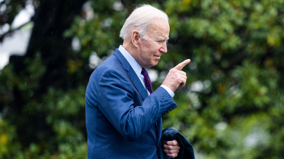 US President Joe Biden points out of frame