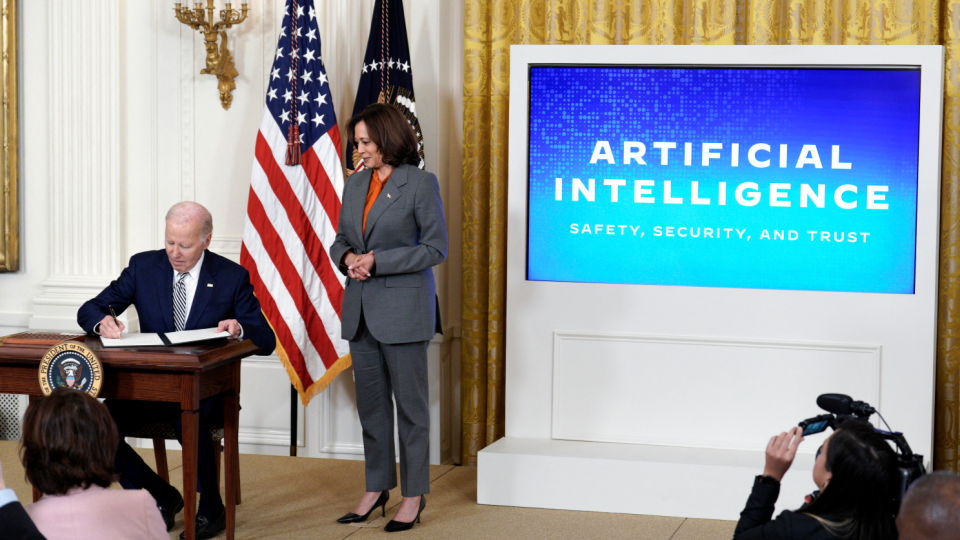 US President Joe Biden with Vice President Kamala Harris signs an executive order during the Artificial Intelligence event at the White House on October 30, 2023