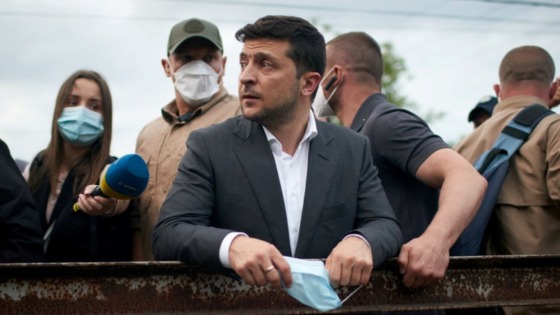 Ukrainian President Volodymyr Zelenskiy visits a settlement affected by heavy rainfall and flooding