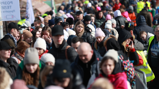 Ukrainian refugees form a long line to cross the borderline in Medyka