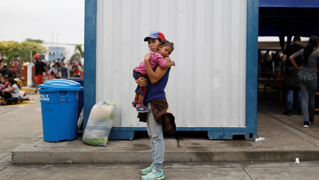 Venezuelan migrant Andraimi Laya, 22, poses for a picture carrying her daughter Jessy