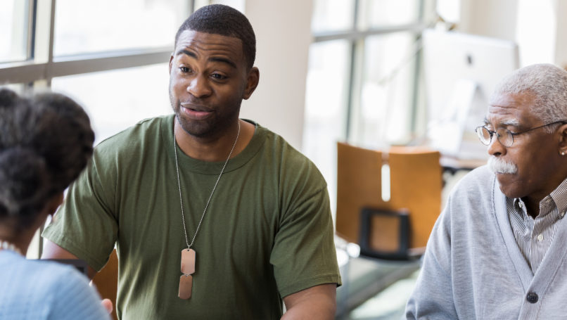 Veteran with classmates in library