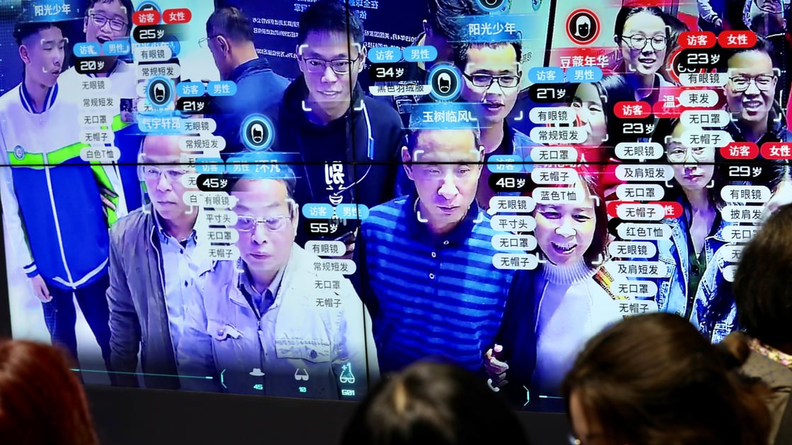 Visitors are seen at a screen displaying facial recognition technology at the Digital China Exhibition in Fuzhou-1