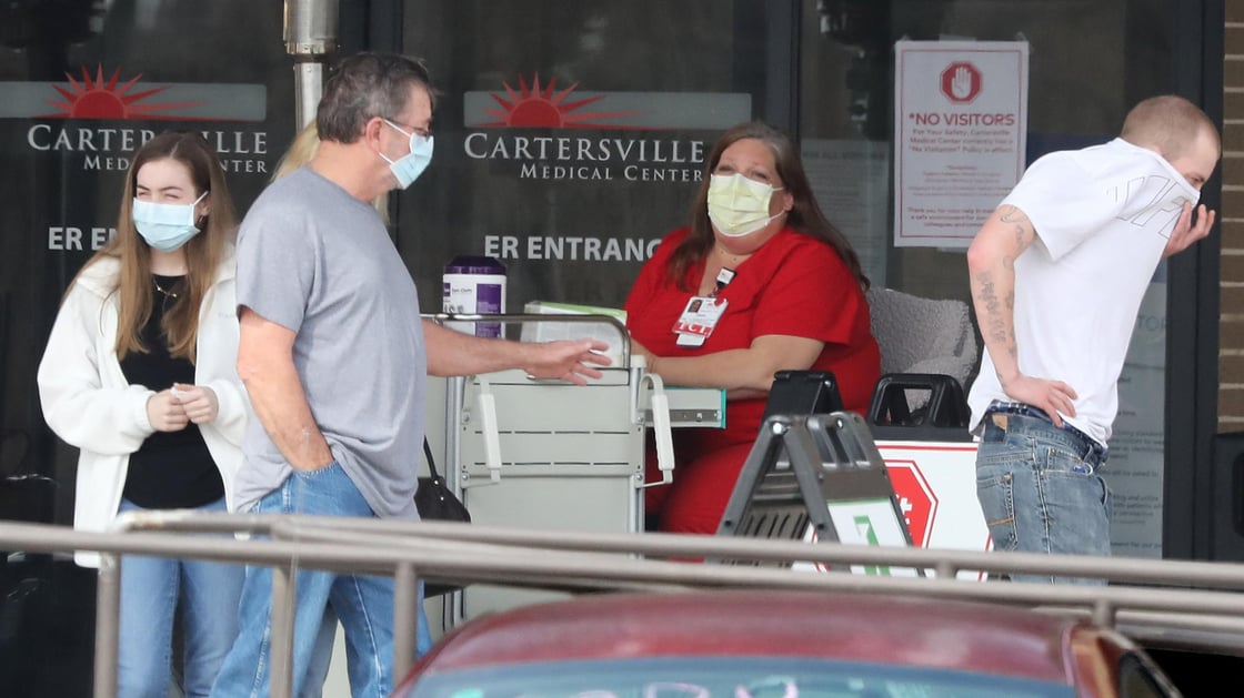 Visitors leave the screening station for coronavirus in front of the emergency department entrance at Cartersville Medical Center