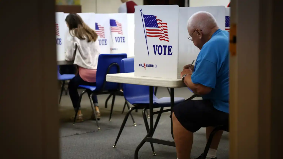 Voters fill out ballots at a polling station during the 2022 U.S. midterm election in downtown Harrisburg, Pennsylvania