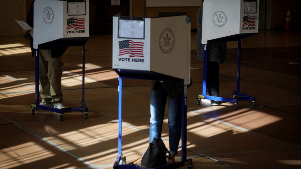 Voters fill out ballots at a polling station during voting for the 2022 midterm elections in Brooklyn