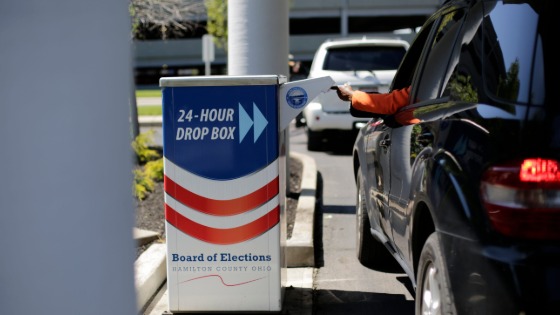 Voters place ballots in a drop box at the Hamilton County Board of Elections in Norwood